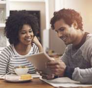 Smiling couple looking at Tablet together